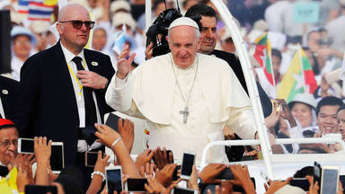 Pope Francis waves to Catholic faithful as he arrives to lead a mass at Kyite Ka San Football Stadium in Yangon, Myanmar