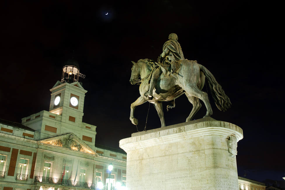 Carlos III statue and clock tower, night view. Puerta del Sol, Madrid, Spain.