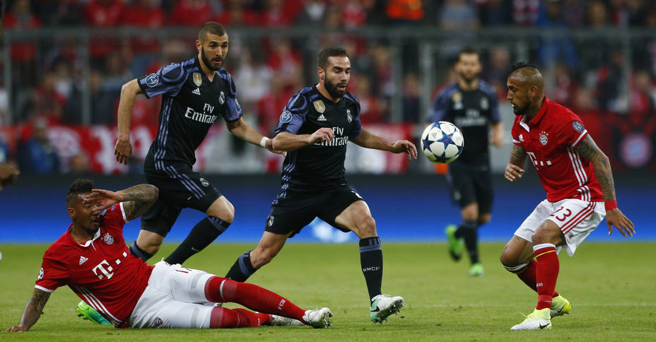 Real Madrids Daniel Carvajal and Karim Benzema in action with Bayern Munichs Jerome Boateng and Arturo Vidal