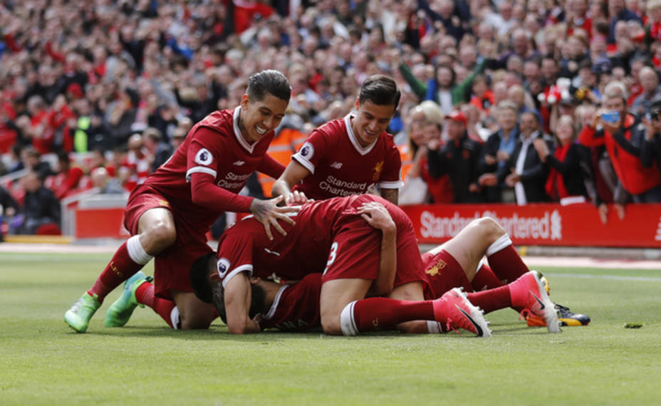 Liverpools Adam Lallana celebrates scoring their third goal with team mates
