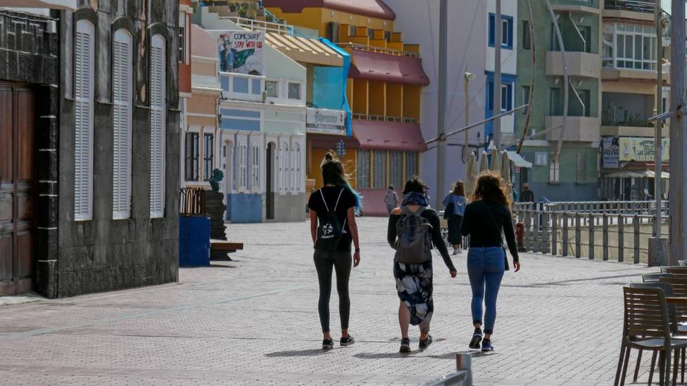 Imagen de tres jóvenes caminando por un paseo marítimo en Las Palmas de Gran Canaria - Europa Press