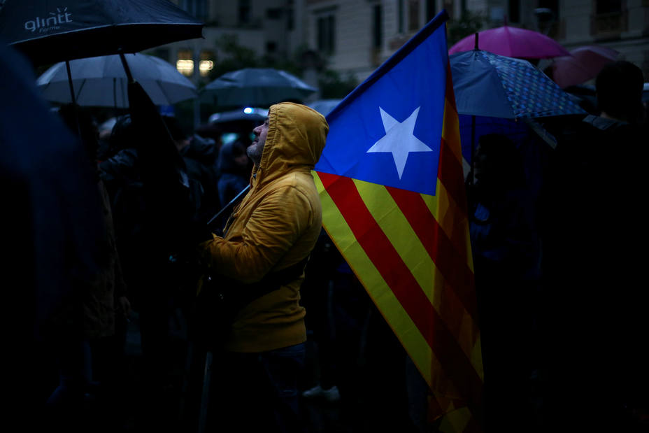 Un manifestante independentista sostiene una estelada este jueves en Barcelona. REUTERS