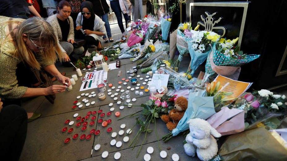 People take part in a vigil for the victims of an attack on concert goers at Manchester Arena, in central Manchester
