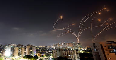 Streaks of light are seen as Israels Iron Dome anti-missile system intercepts rockets launched from the Gaza Strip towards Israel, as seen from Ashkelon