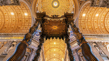Low angle interior view of the baldacchino and main dome, St. Peters Basilica, Vatican City