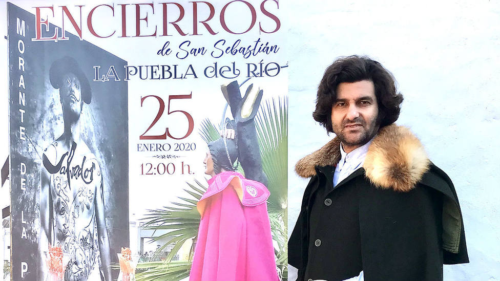 Morante junto al cartel anunciador de los festejos taurinos de La Puebla del Río
