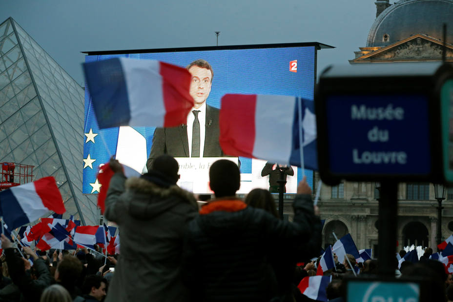 President Elect Emmanuel Macron is seen on a giant screen near the Louvre museum after results were announced in the second round vote of the 2017 French presidential elections