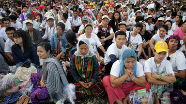 Catholic faithful attend a mass led by Pope Francis at Kyite Ka San Football Stadium in Yangon, Myanmar