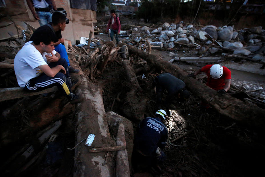 Rescue agencies look for bodies in a destroyed area after heavy rains caused several rivers to overflow, pushing sediment and rocks into buildings and roads in Mocoa