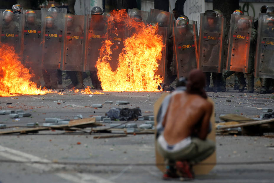 Demonstrators clash with riot security forces at a rally during a strike called to protest against Venezuelan President Nicolas Maduros government in Caracas