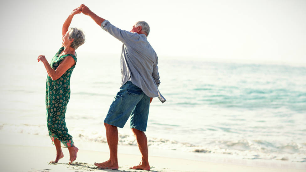 Senior,Couple,Dancing,At,Beach,On,Sunny,Day
