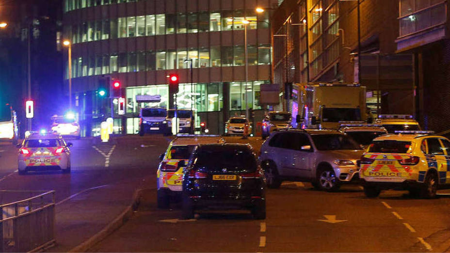 Vehicles are seen near a police cordon outside the Manchester Arena, where U.S. singer Ariana Grande had been performing, in Manchester, northern England, Britain