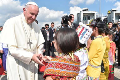 Pope Francis is welcomed as he arrives at Yangon International Airport