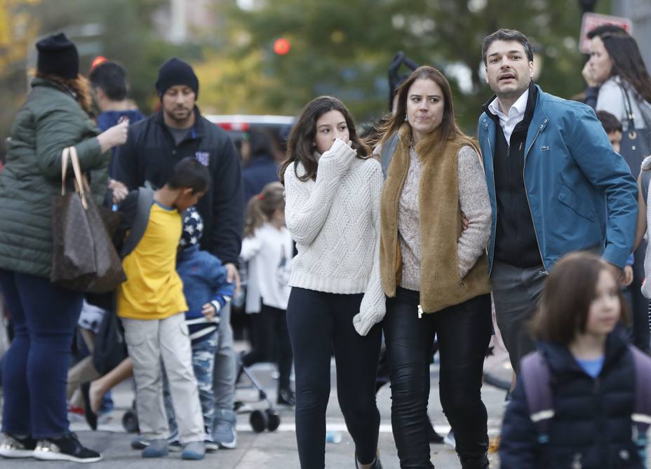 Parents pick up their children from P.S./I.S.-89 school after a shooting incident in New York City