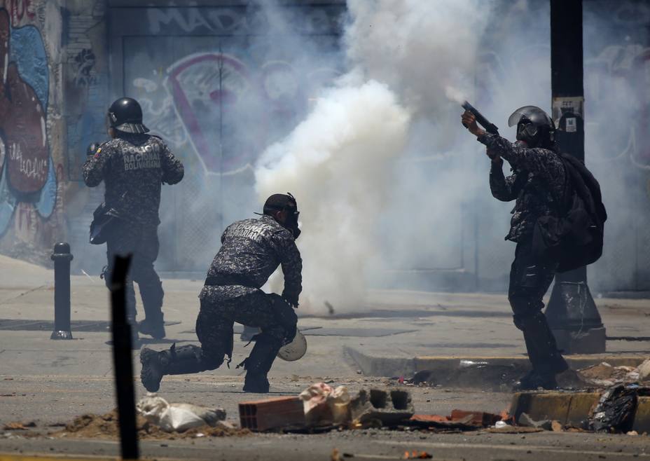 Security forces members fire tear gas canisters after clashes broke out while the Constituent Assembly election was being carried out in Caracas