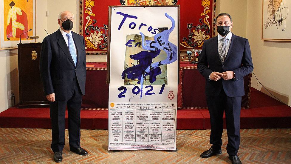 Ramón Valencia y Ricardo Sánchez, delegado de la Junta, junto a los carteles de la temporada en Sevilla