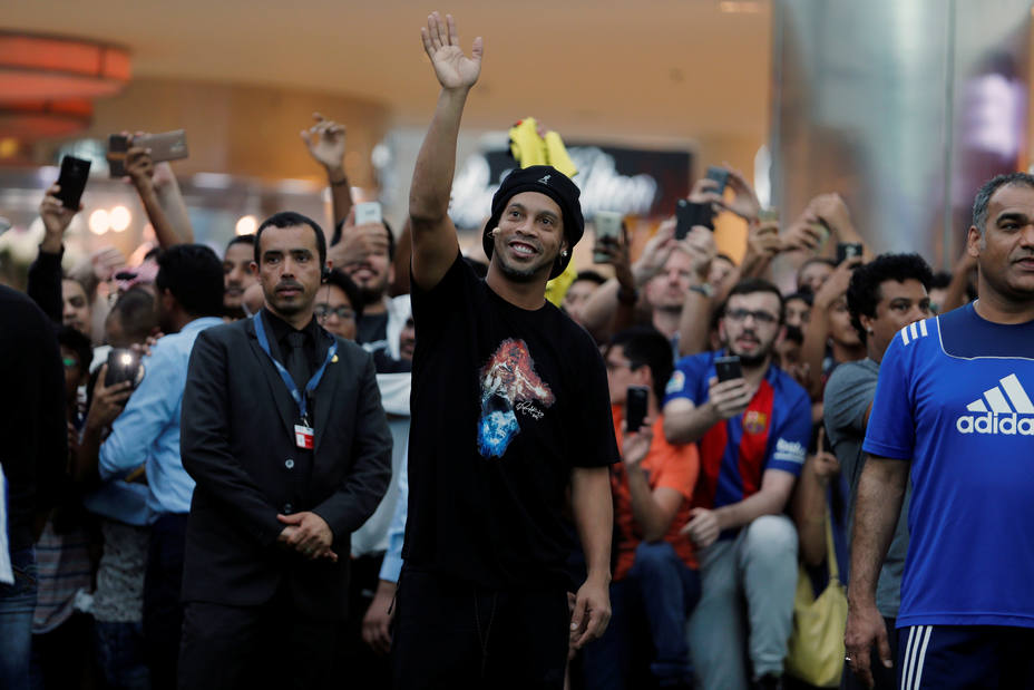 Ronaldinho waves at his fans as he arrives for a show as part of 67th FIFA Congress in Manama