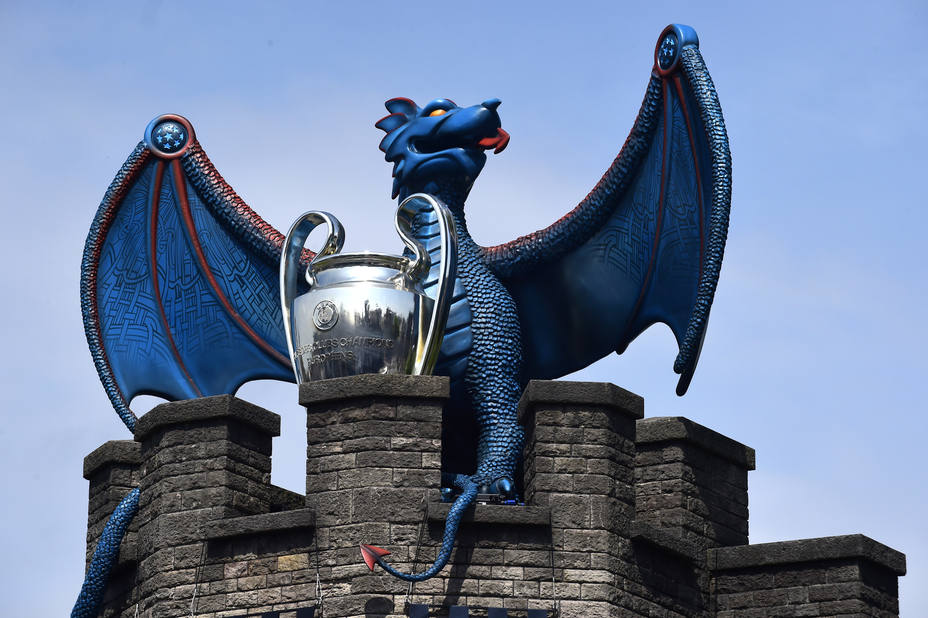 A replica of the UEFA Champions League trophy is displayed with a dragon on the walls of Cardiff Castle