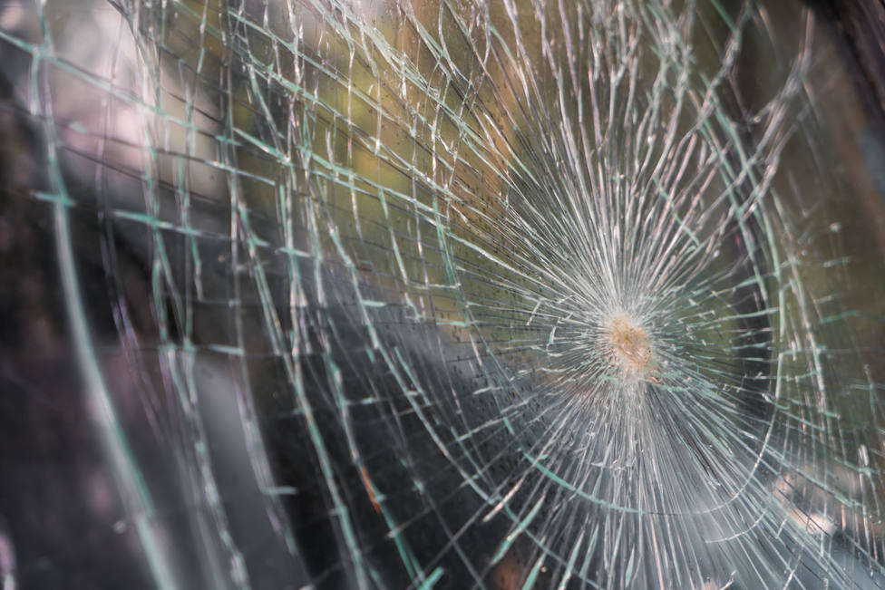 ctv-tek-glass-broken-cracks-splinters-in-front-of-car-filtered-image