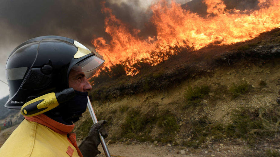 A firefighter stands near a firewall in Tablado, near Muniellos park, Asturias