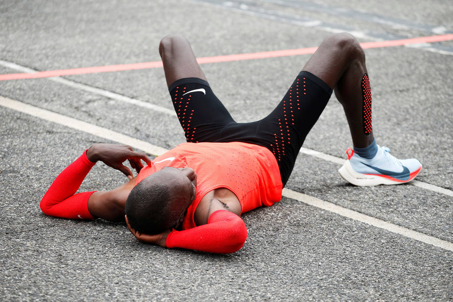 Kipchoge reacts after crossing the finish line during an attempt to break the two-hour marathon barrier at the Monza circuit.