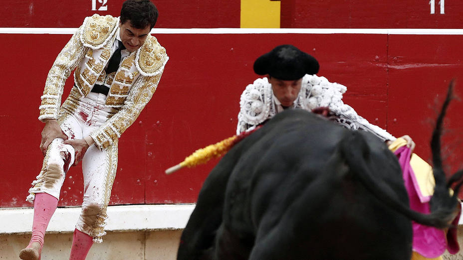 Paco Ureña observando la cornada que le infirió el cuarto toro del Puerto de San Lorenzo en Pamplona