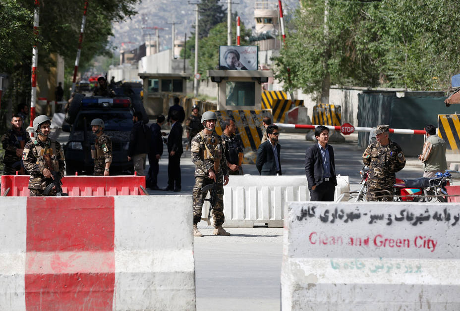 Afghan security forces stand guard near the site of a blast in Kabul, Afghanistan